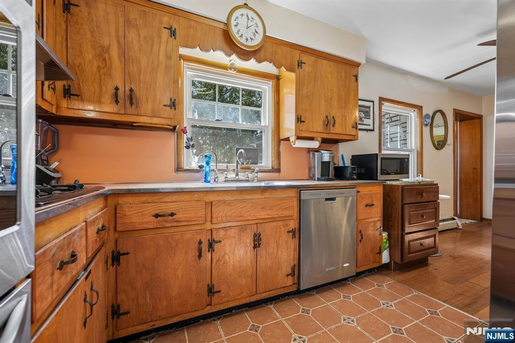 140 Francisco Avenue Rutherford, NJ 07070 - Photo 11 of 25 a kitchen with stainless steel appliances granite countertop a sink and cabinets