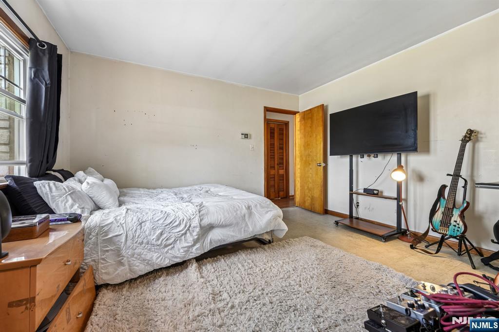 140 Francisco Avenue Rutherford, NJ 07070 - Photo 14 of 25 a bedroom with bed and a flat screen tv
