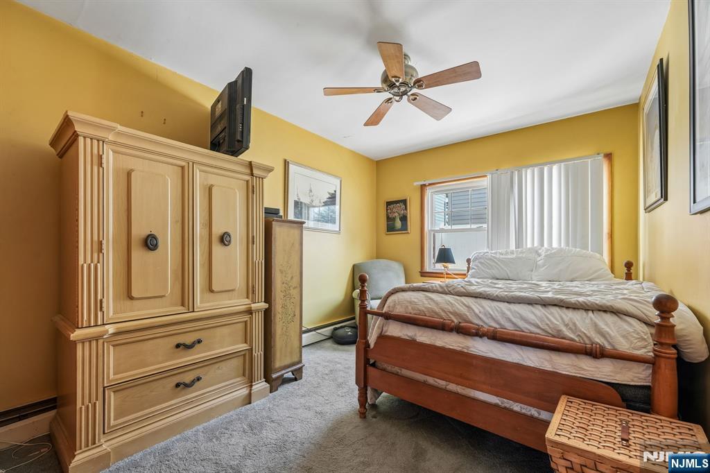 140 Francisco Avenue Rutherford, NJ 07070 - Photo 16 of 25 a bedroom with a bed and a chandelier