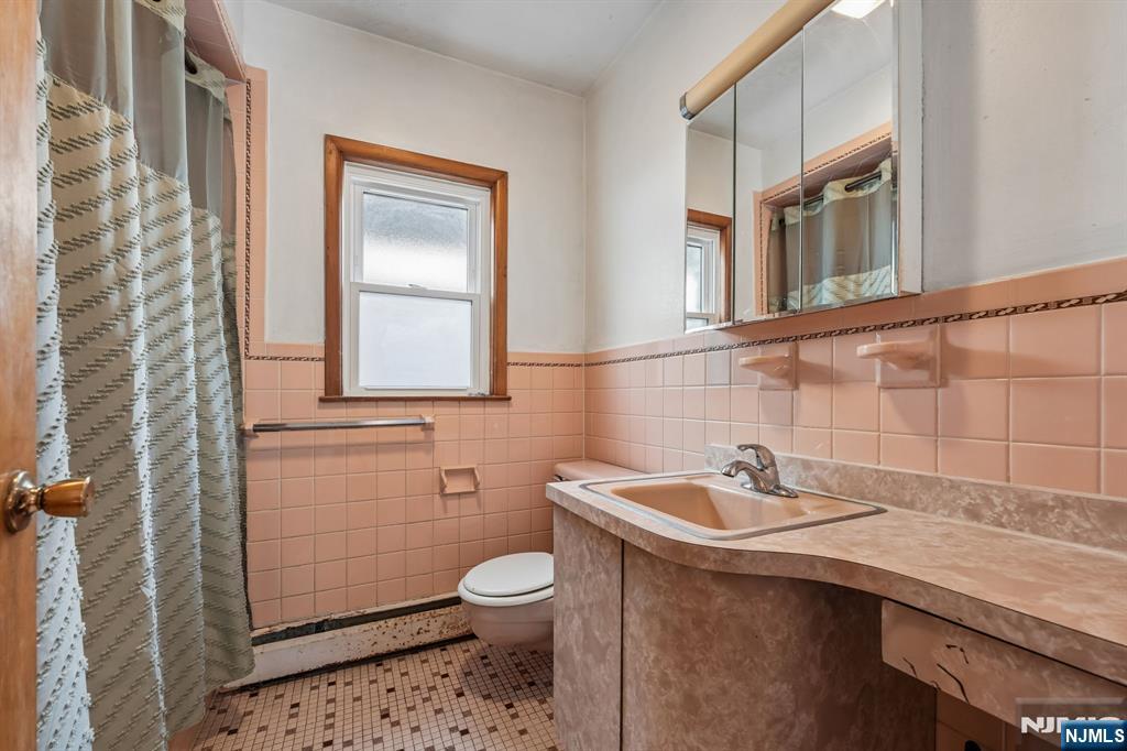 140 Francisco Avenue Rutherford, NJ 07070 - Photo 18 of 25 a bathroom with a sink a toilet and mirror
