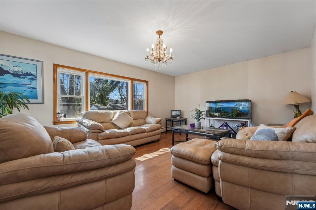 140 Francisco Avenue Rutherford, NJ 07070 - Photo 3 of 25 a living room with furniture ceiling fan and a flat screen tv