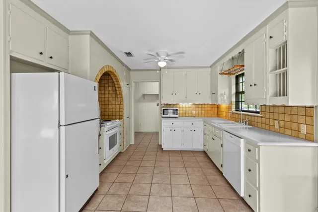 a view of a kitchen with white cabinets