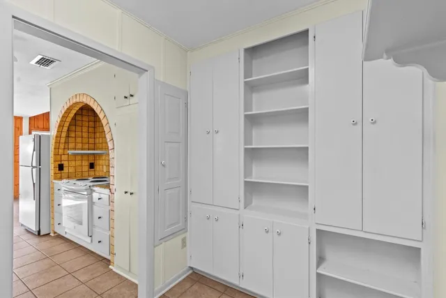 a large room with a large window and chandelier