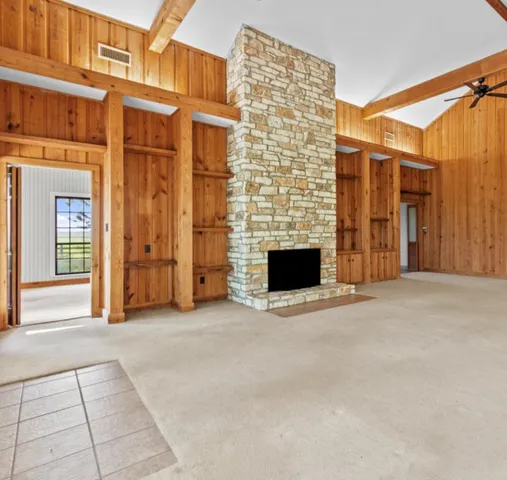a view of an empty room with a fireplace