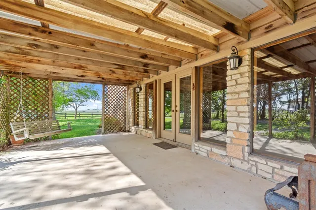 a house with huge green field in front of it