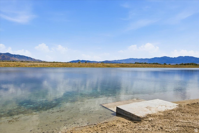 21 Pier Place Tooele, UT 84074 - Photo 98 of 112 Expansive water frontage featuring a concrete ramp, clear water visibility, and distant mountain backdrops