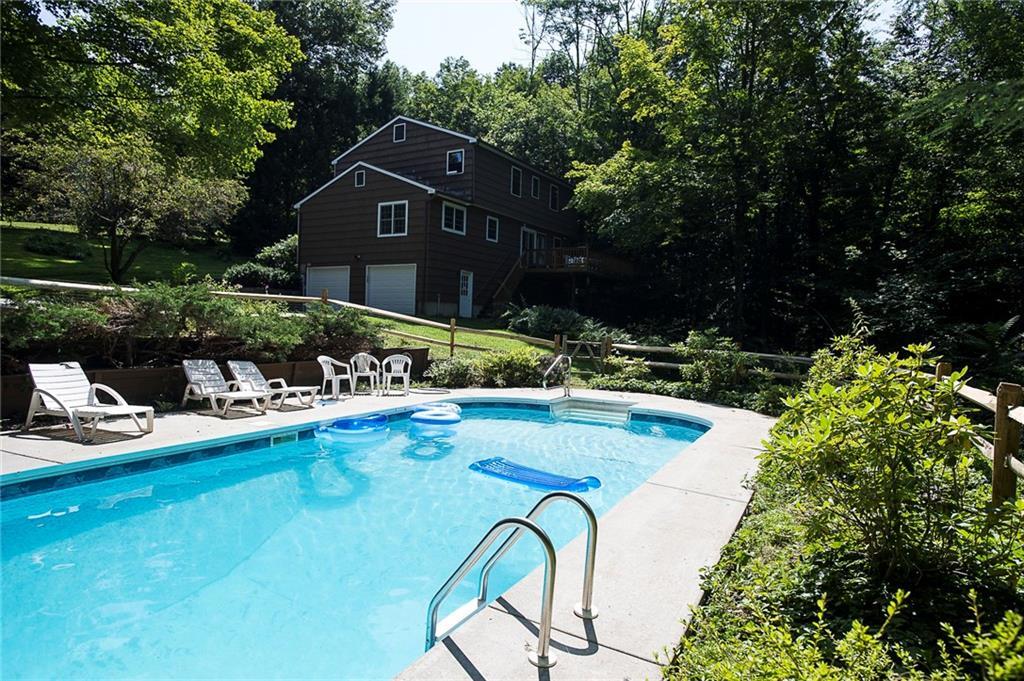12 Church Hill Road New Milford, CT 06776 - Photo 1 of 1 a front view of a house with swimming pool and patio