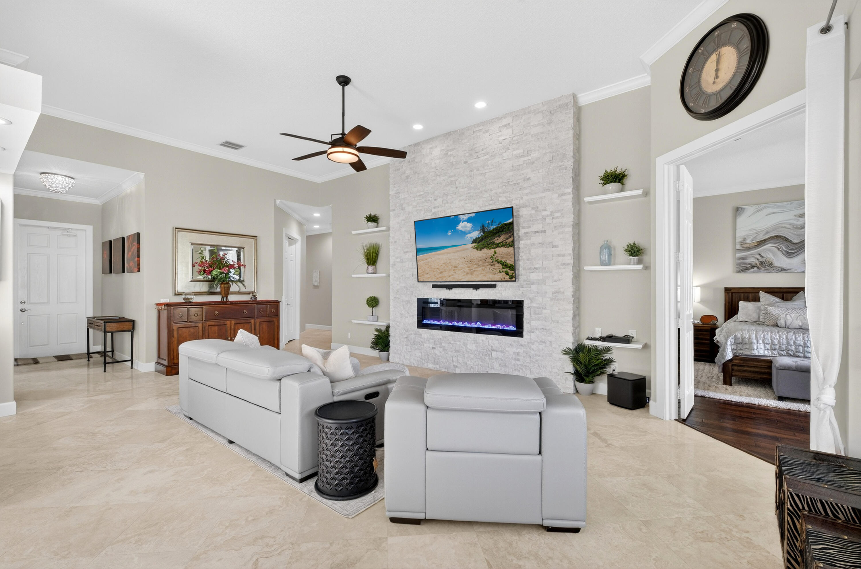 a living room with furniture a chandelier and a window