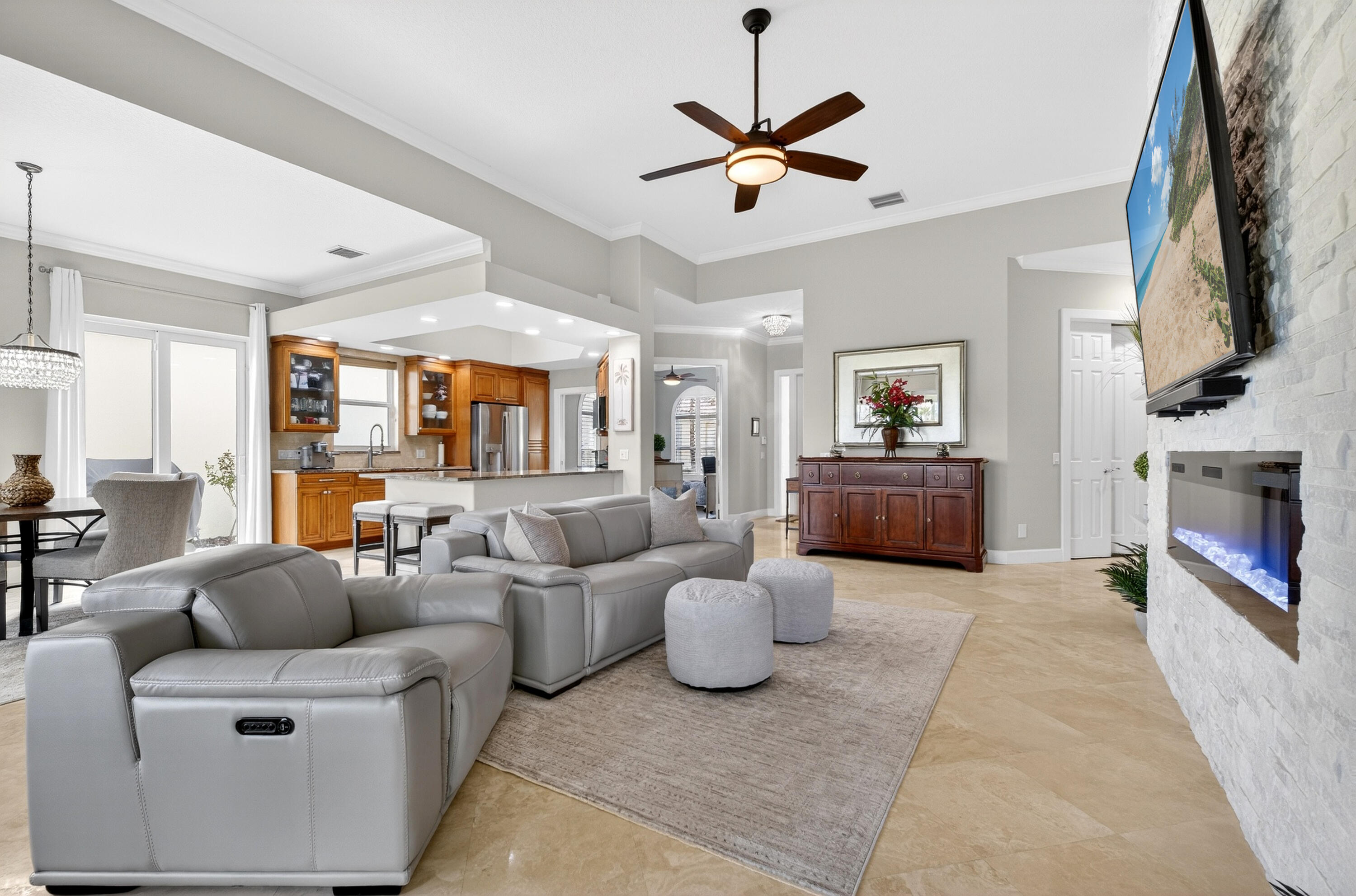 8223 Pine Cay Road Wellington, FL 33414 - Photo 14 of 60 a living room with furniture and a fireplace