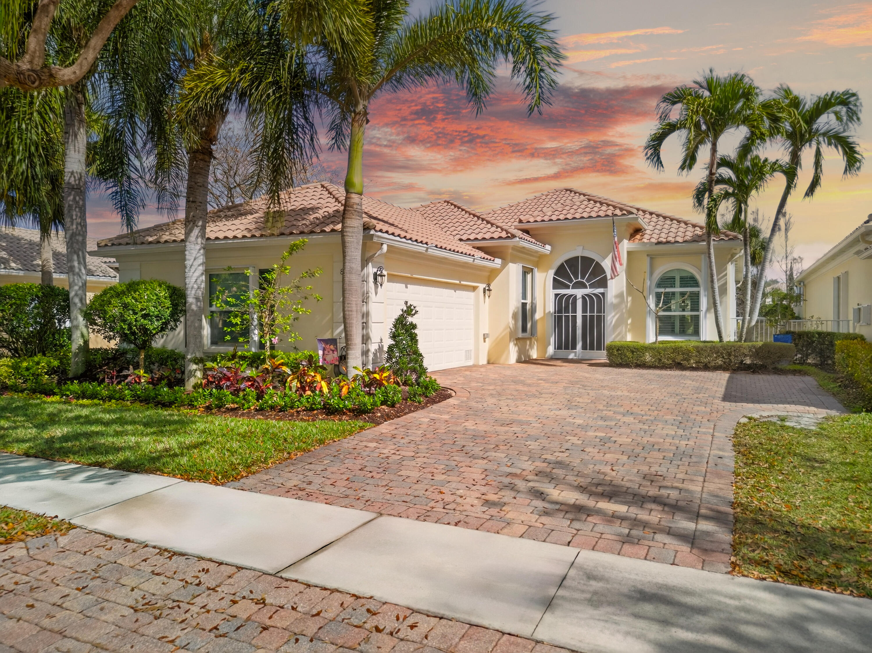 8223 Pine Cay Road Wellington, FL 33414 - Photo 2 of 60 a front view of multiple houses with yard