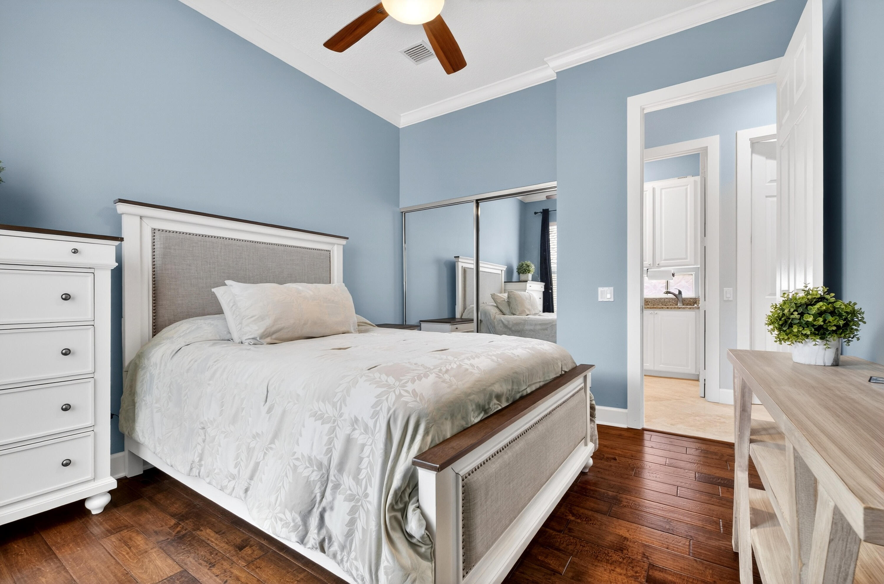 8223 Pine Cay Road Wellington, FL 33414 - Photo 25 of 60 a spacious bedroom with a bed and a potted plant
