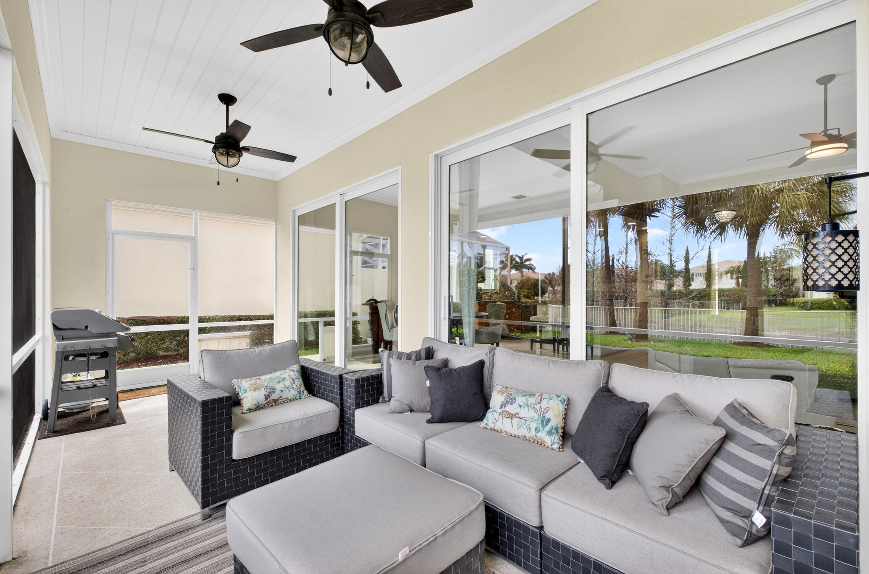 8223 Pine Cay Road Wellington, FL 33414 - Photo 31 of 60 a living room with furniture and a floor to ceiling window