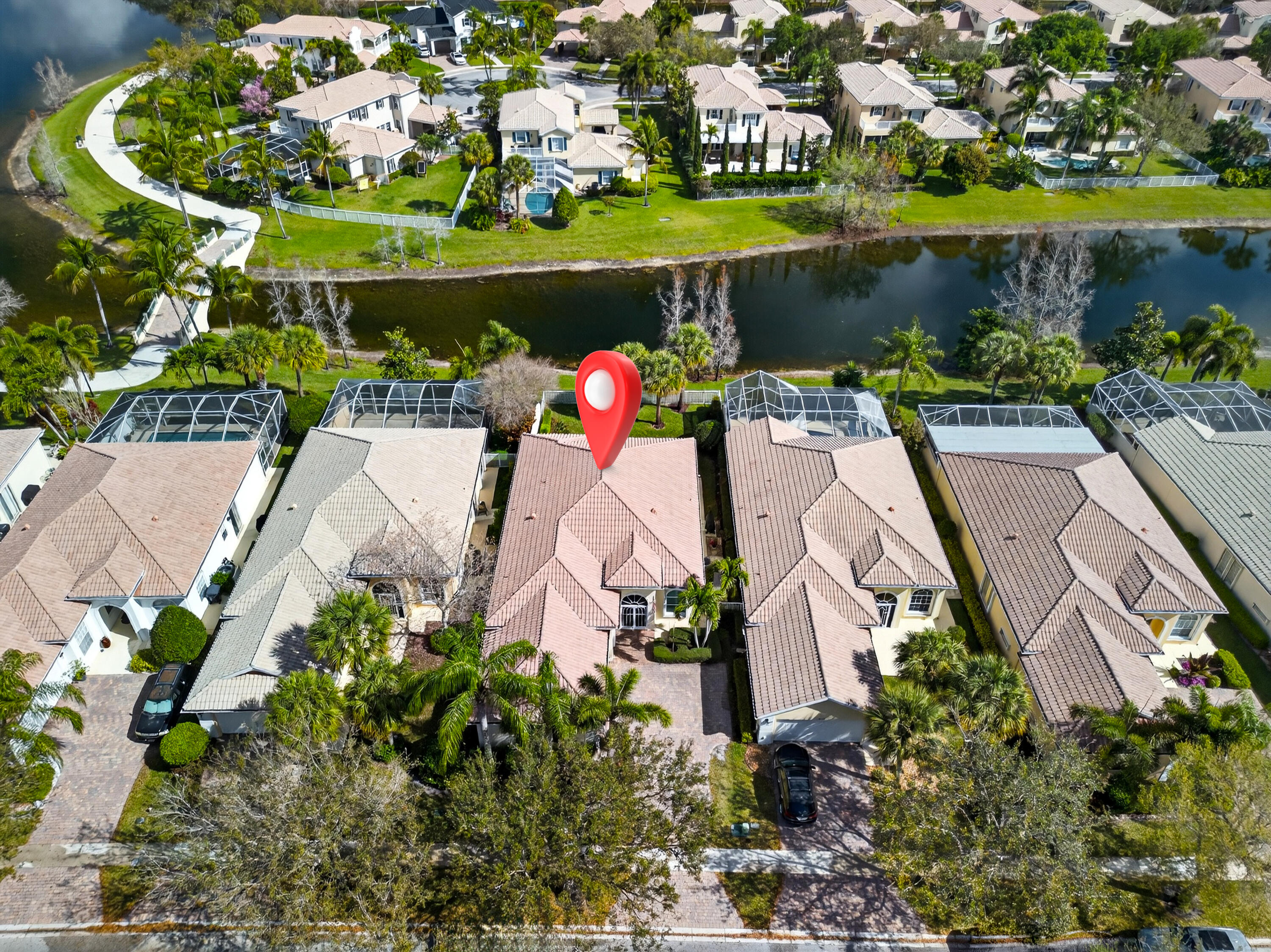 8223 Pine Cay Road Wellington, FL 33414 - Photo 46 of 60 an aerial view of a house with a garden and lake view