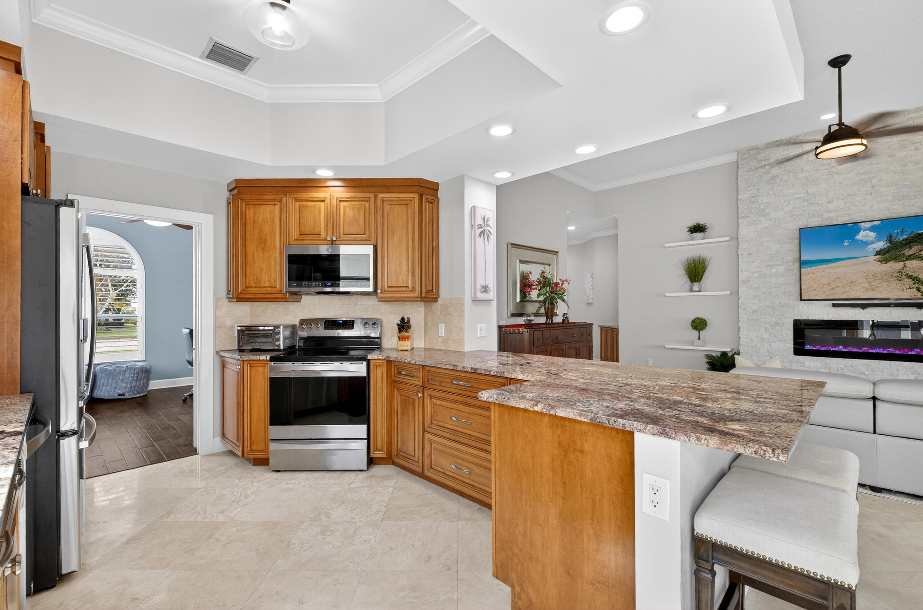 8223 Pine Cay Road Wellington, FL 33414 - Photo 5 of 60 a kitchen with stainless steel appliances granite countertop a stove and a sink