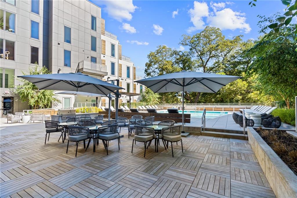 775 Juniper Street Northeast, Unit 227 Atlanta, GA 30308 - Photo 21 of 42 a view of a dinning table and chairs in patio area of the house