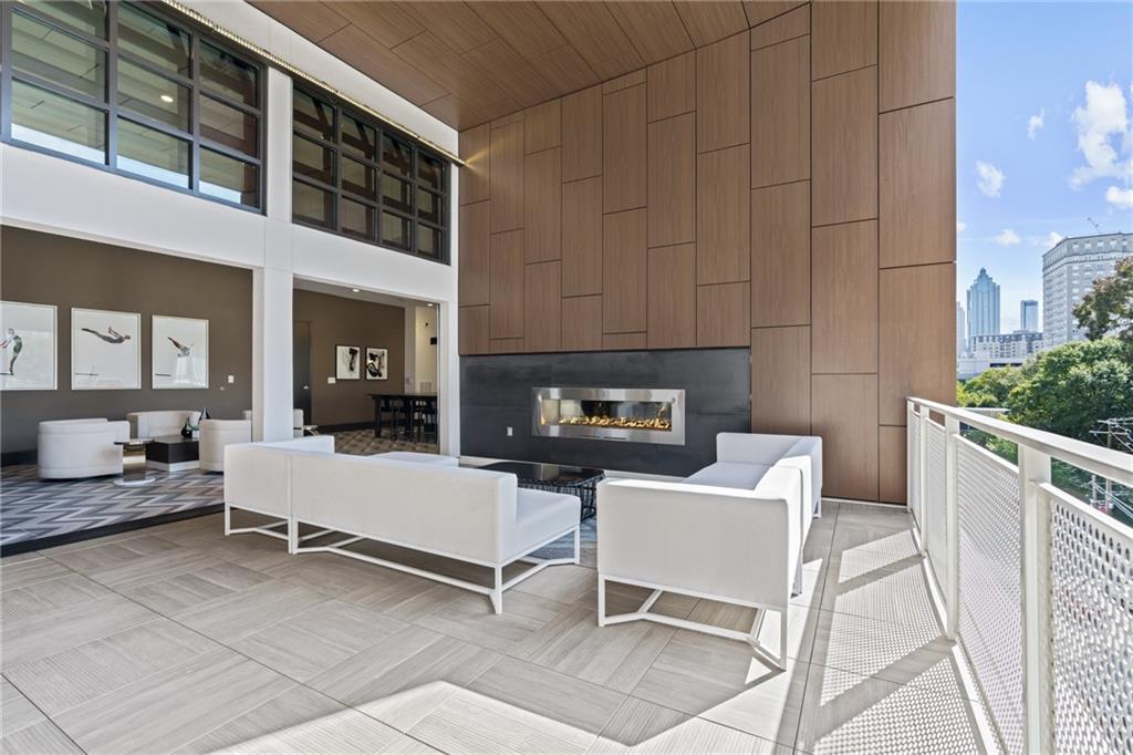 775 Juniper Street Northeast, Unit 227 Atlanta, GA 30308 - Photo 35 of 42 a living room with furniture a fireplace and a table