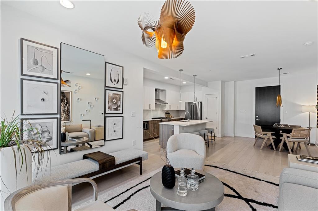 775 Juniper Street Northeast, Unit 227 Atlanta, GA 30308 - Photo 5 of 42 a living room with furniture kitchen view and a dining table