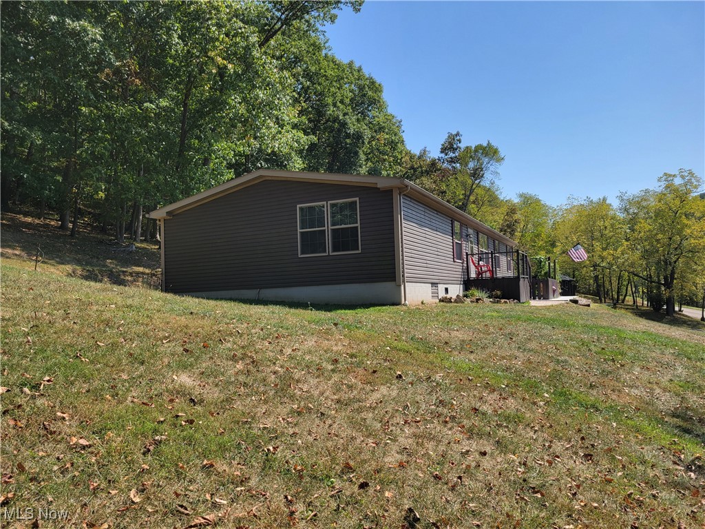 85645 Merryman Road Cadiz, OH 43907 - Photo 3 of 38 View of property exterior with a lawn
