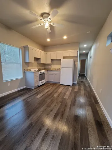 a view of kitchen with cabinets and wooden floor