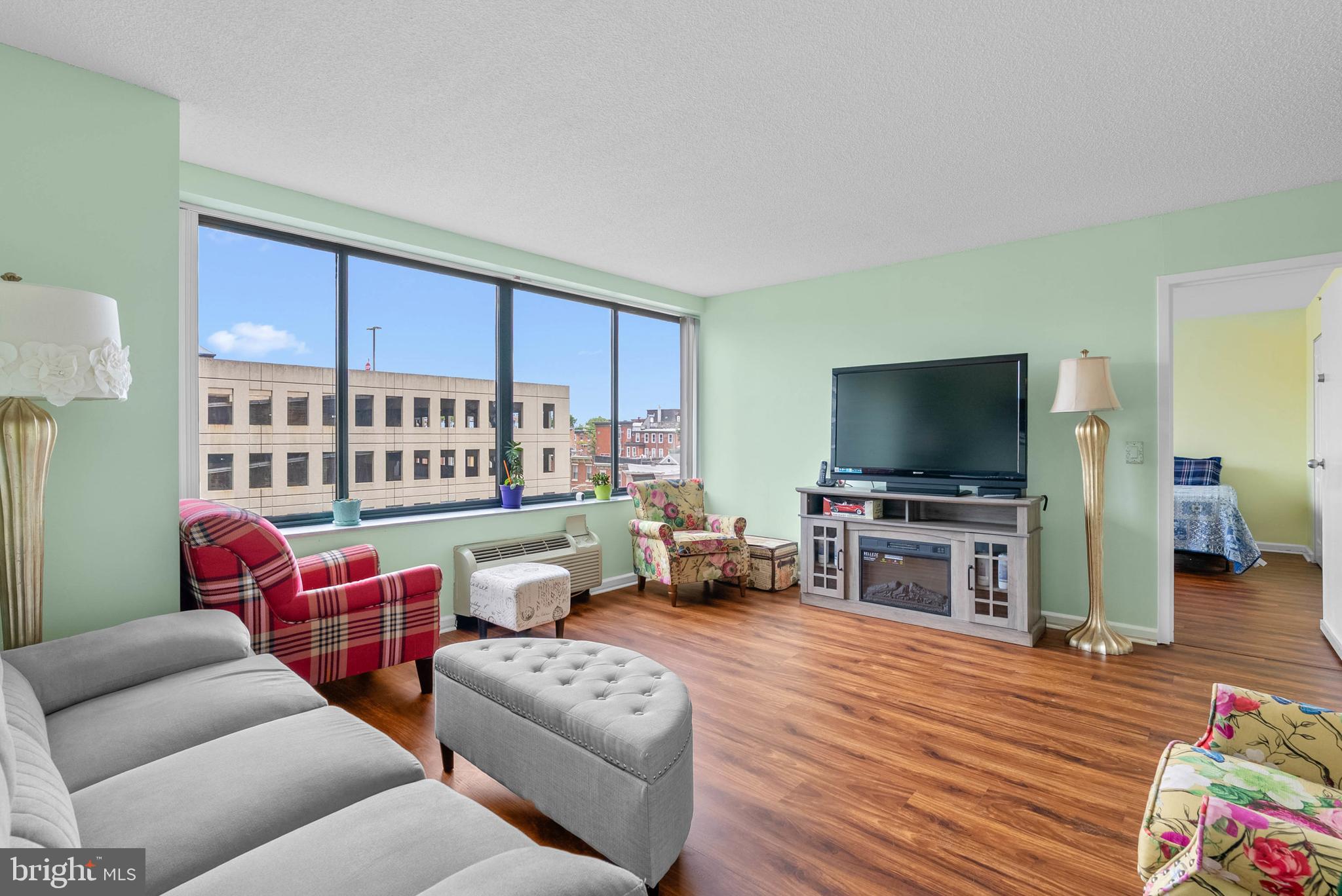 2001 Hamilton Street, Unit 507 Philadelphia, PA 19130 - Photo 7 of 41 a living room with furniture and a flat screen tv