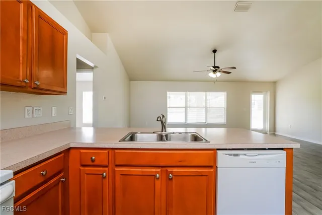 a kitchen with stainless steel appliances granite countertop a sink and a cabinets