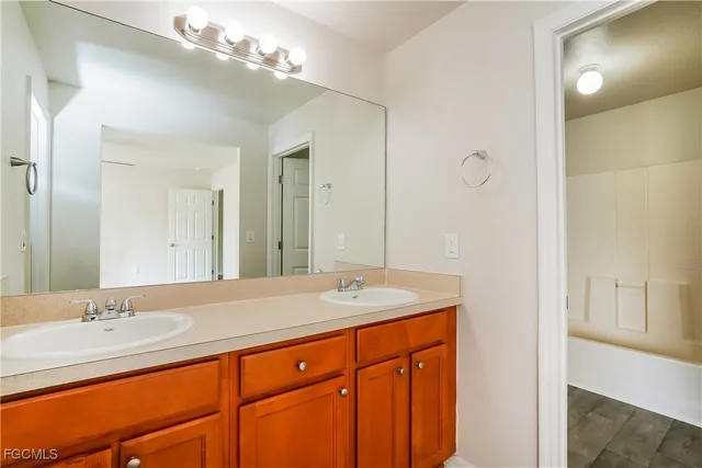 a bathroom with a sink double vanity and a mirror