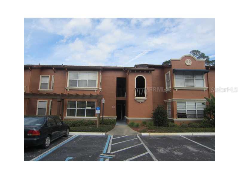5116 Conroy Road, Unit 415 Orlando, FL 32811 - Photo 1 of 1 a view of residential houses with cars parked in front of it
