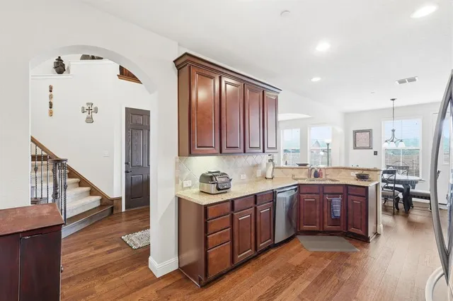 a kitchen with lots of counter top space and painting on the wall