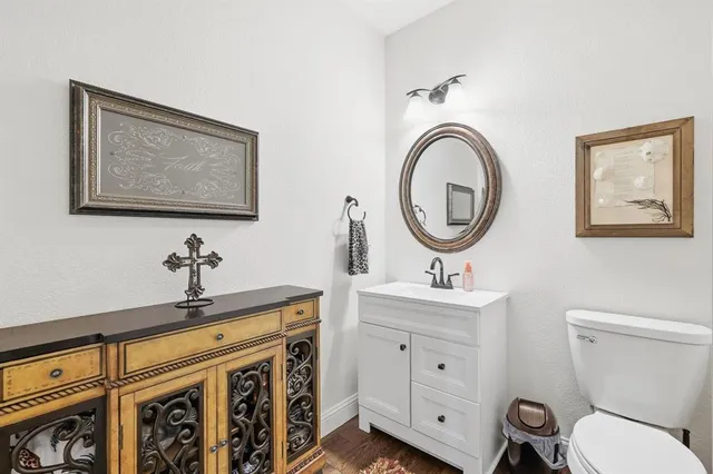 a bathroom with a sink a mirror and a toilet