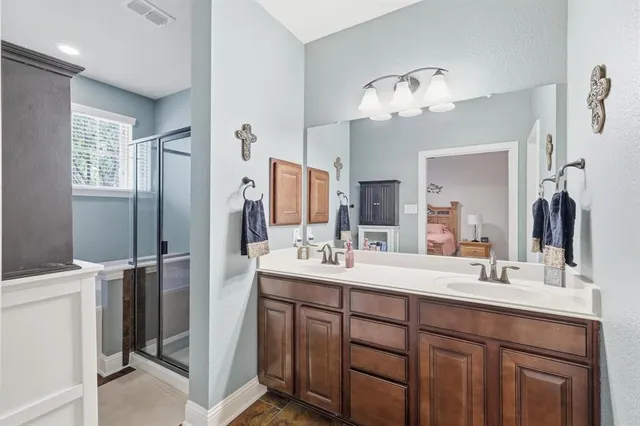 a bathroom with a double vanity sink and a mirror