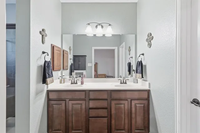 a bathroom with a double vanity sink and a mirror