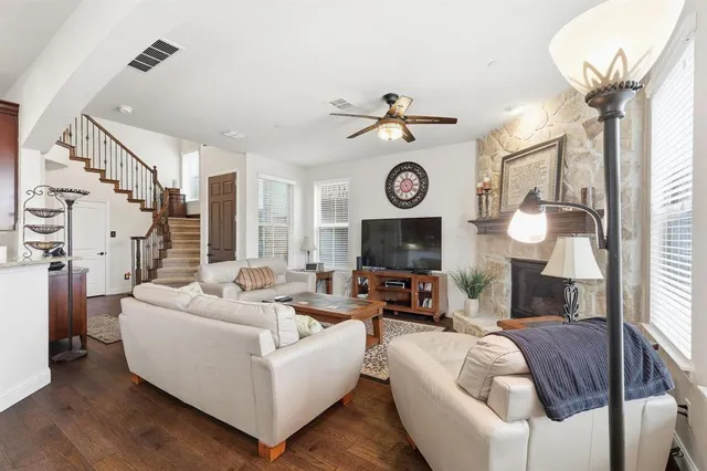 a living room with furniture a clock and a fireplace