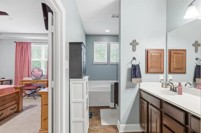 a bathroom with a sink vanity and a mirror