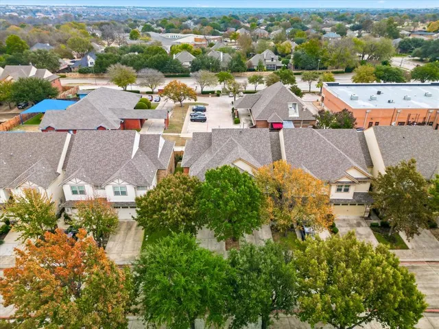 an aerial view of residential houses with outdoor space and street view