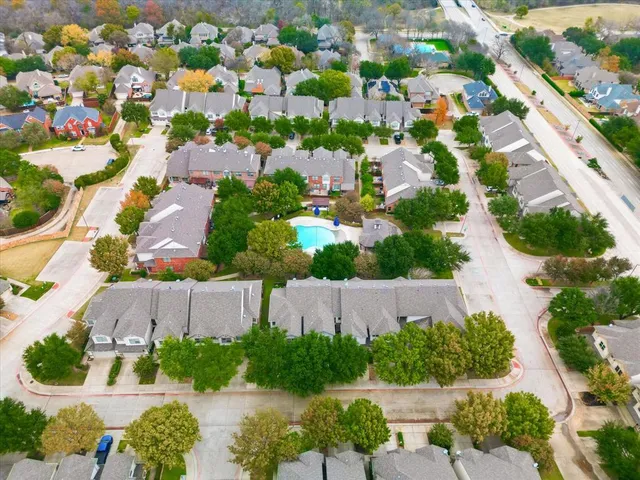 an aerial view of residential houses with outdoor space and street view