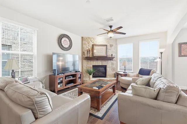 a living room with furniture a large window and a fireplace