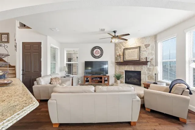 a living room with furniture and a fireplace