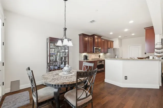 a view of a dining room with furniture wooden floor and a chandelier
