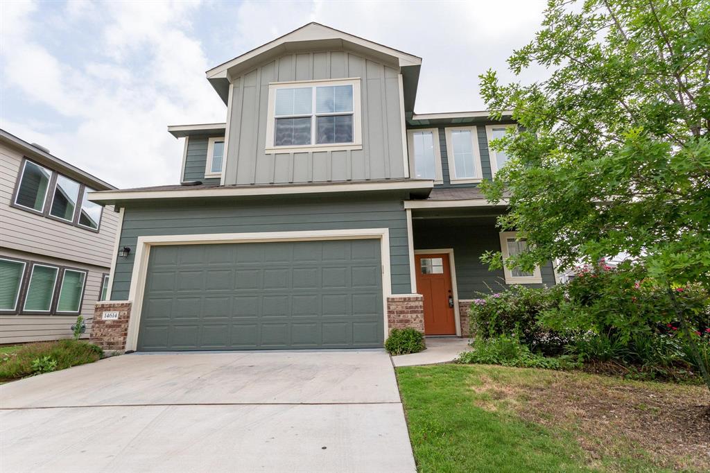 14614 Frankel Loop Pflugerville, TX 78660 - Photo 1 of 15 A welcoming front exterior showcasing a multi-textured facade and mature landscaping.