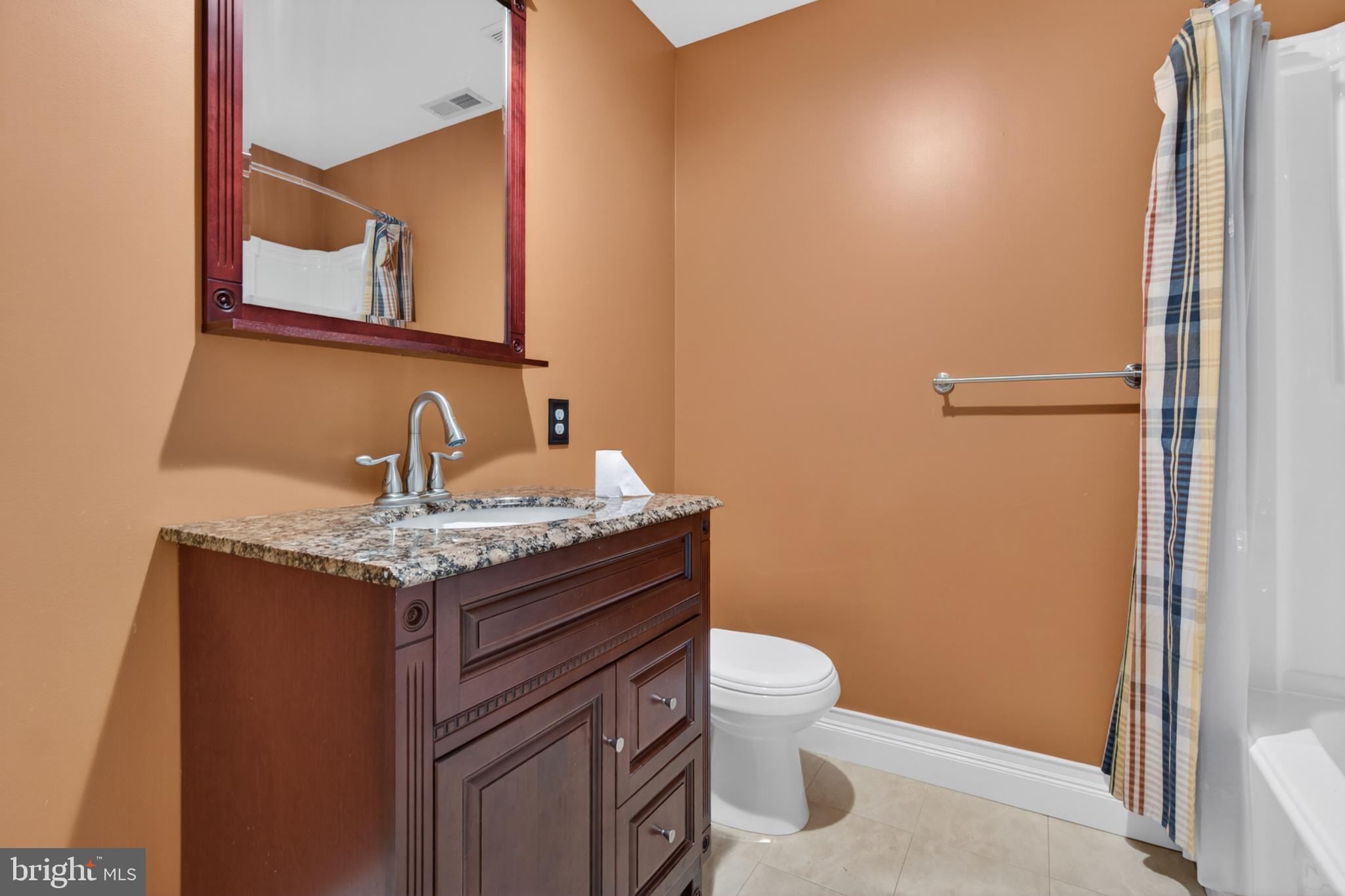 117 State Avenue Lindenwold, NJ 08021 - Photo 41 of 58 a bathroom with a granite countertop sink toilet and mirror