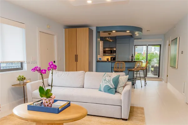 a living room with furniture and a chandelier