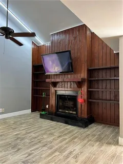 a room with fireplace and a wooden floor