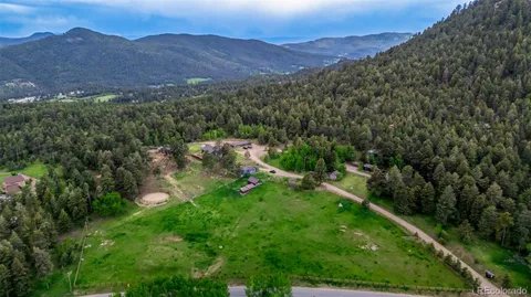 a view of a lush green hillside and a building