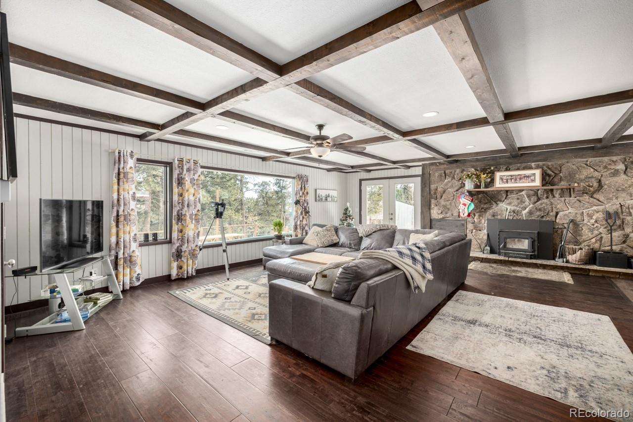 8537 Doubleheader Ranch Road Morrison, CO 80465 - Photo 13 of 48 a living room with furniture and a flat screen tv