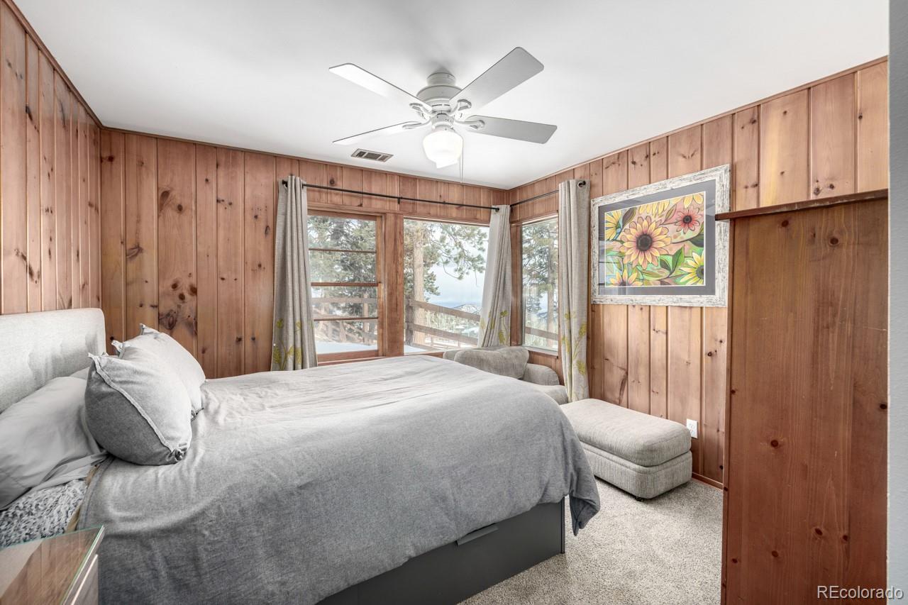 8537 Doubleheader Ranch Road Morrison, CO 80465 - Photo 15 of 48 a bedroom with a large bed and a window