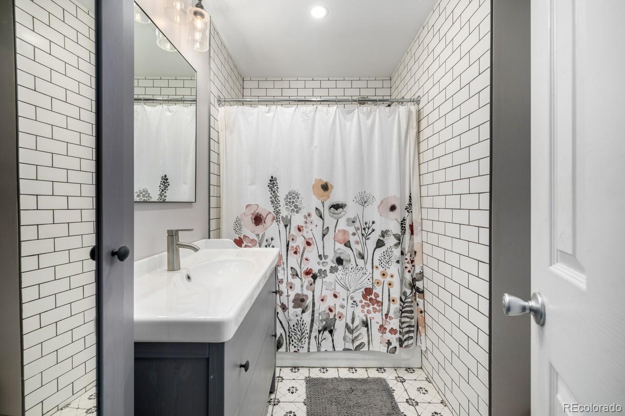 8537 Doubleheader Ranch Road Morrison, CO 80465 - Photo 16 of 48 a bathroom with a sink and a mirror