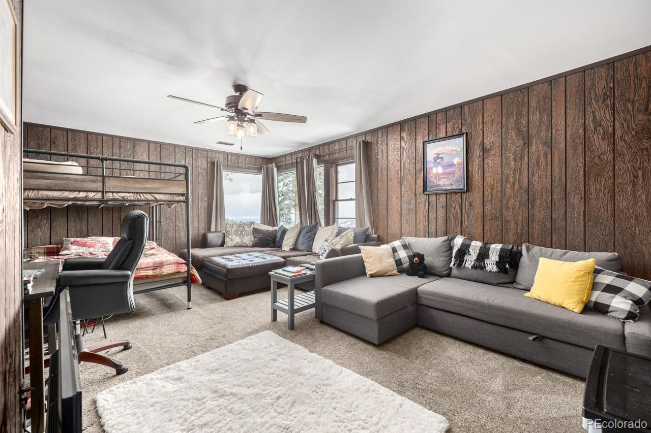 8537 Doubleheader Ranch Road Morrison, CO 80465 - Photo 17 of 48 a living room with furniture and a fireplace