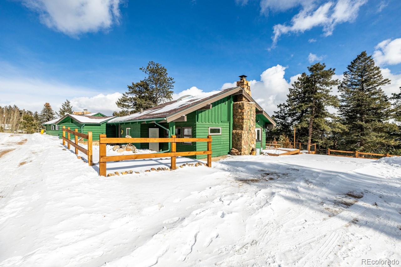 8537 Doubleheader Ranch Road Morrison, CO 80465 - Photo 18 of 48 a view of a house with a backyard porch and sitting area