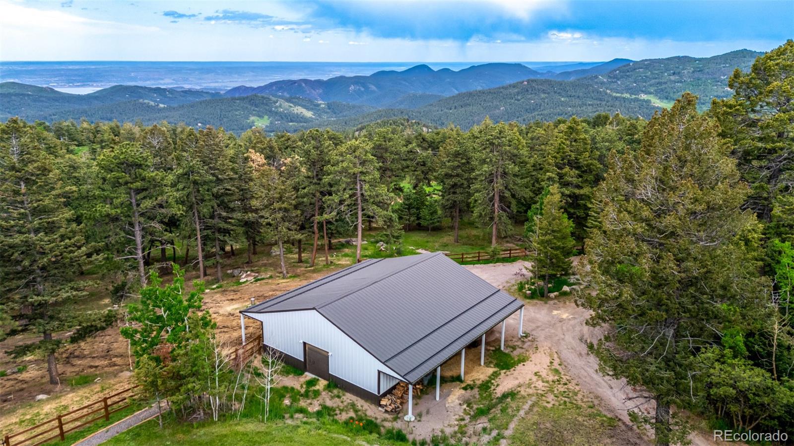 8537 Doubleheader Ranch Road Morrison, CO 80465 - Photo 23 of 48 an aerial view of a house with a yard