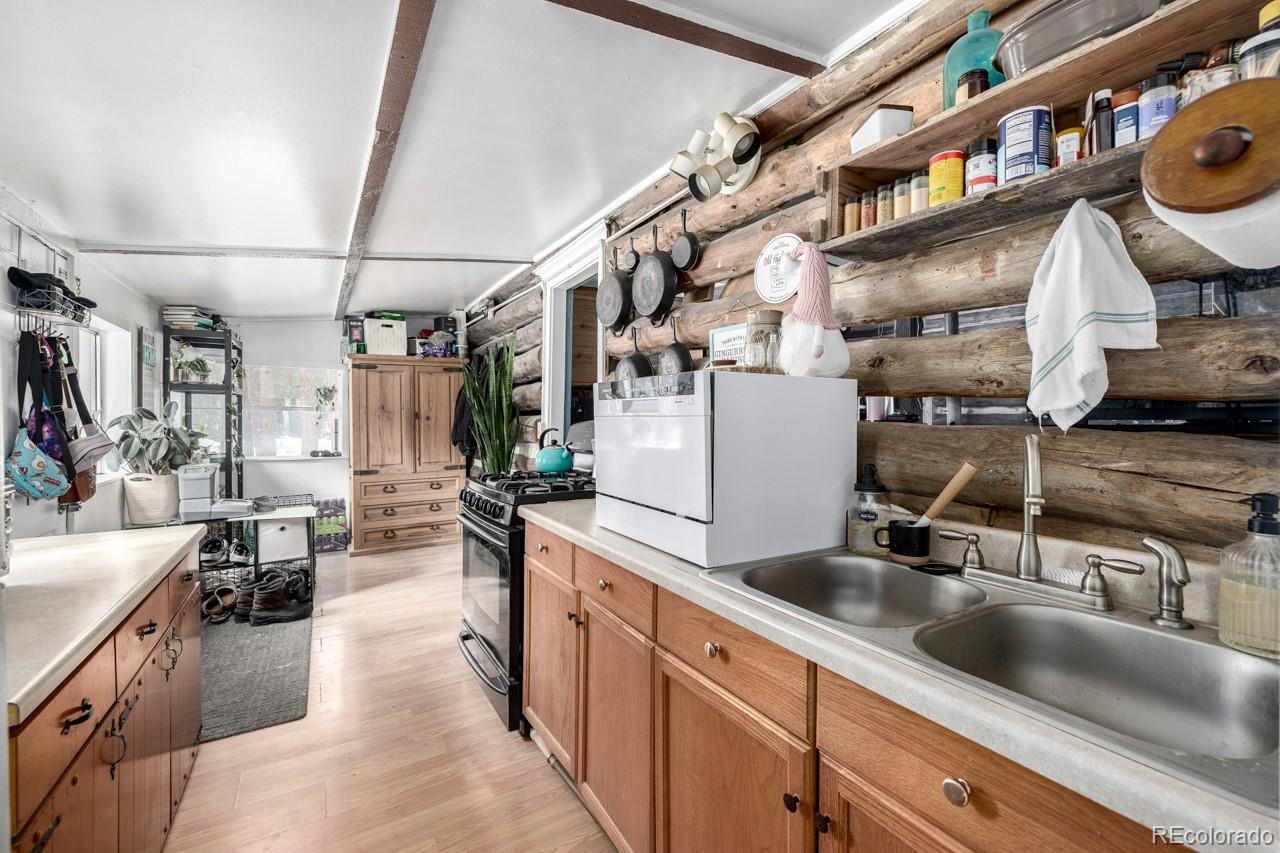 8537 Doubleheader Ranch Road Morrison, CO 80465 - Photo 36 of 48 a kitchen with sink cabinets and washer